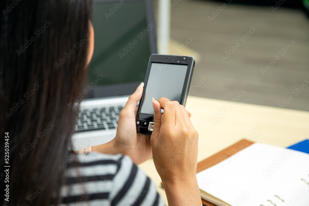 Asian woman hands using stylus pen writing on personnal pda to check information in office room
