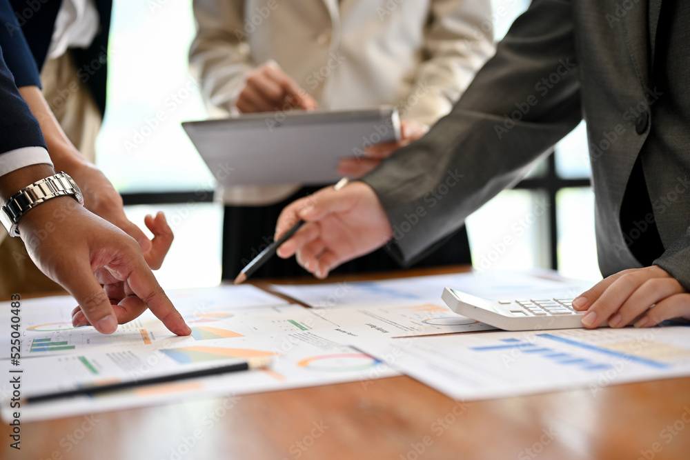 cropped shot, A team of financial analyst working on their financial report. cropped shot, A team of financial analyst working on their financial report.