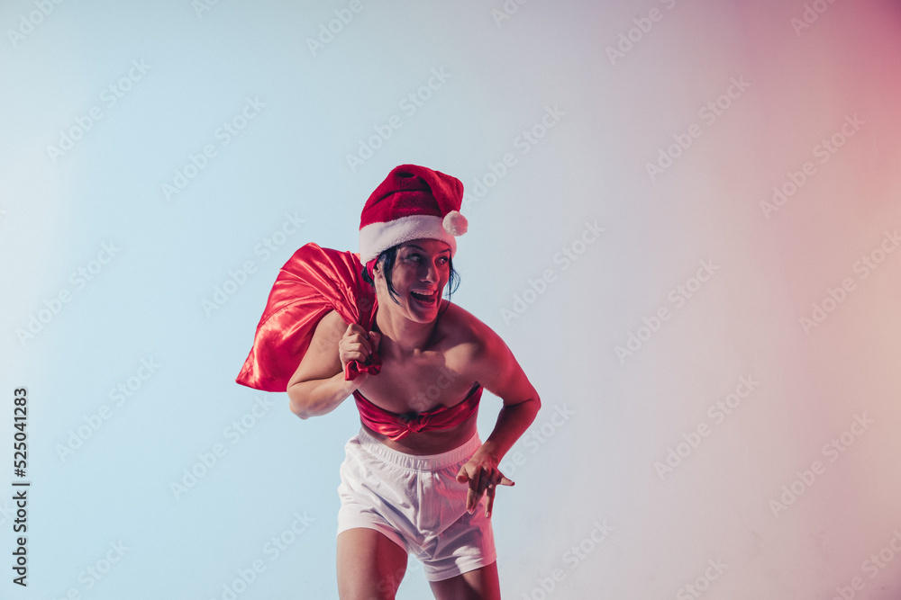 Obraz premium Christmas woman. Santa hat woman. Christmas. Gifts. Holidays. Dream. Gifts. Fun. 