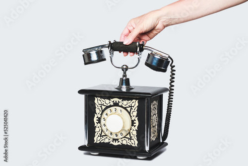 Old vintage telephone on light grey background