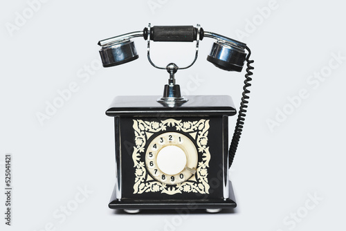 Old vintage telephone on light grey background