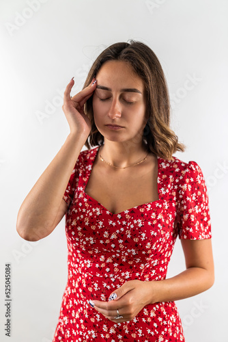 woman suffering fro headache holding her hands behind her head isolated on a white background