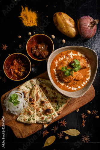 Chicken tikka masala spicy curry meat food Butter chicken with rice and naan bread on dark background close-up