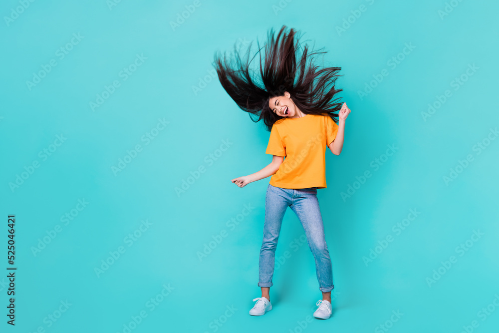 Full length photo of funny brunette lady dance wear t-shirt jeans shoes isolated on turquoise color background Full length photo of funny brunette lady dance wear t-shirt jeans shoes isolated on turquoise color background
