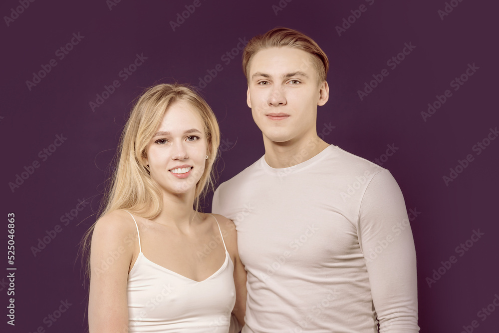 Beautiful young couple in the studio on a lilac background. Beautiful young couple in the studio on a lilac background.