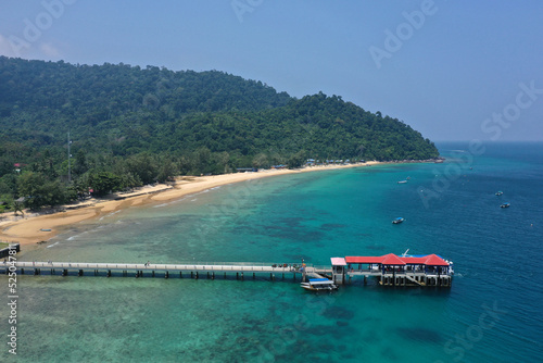 Tioman tropical island drone photo with beautiful blue sea and sky. South Chinese Ocean. South East Asia. The photo is of the jetty where the tourists can expect to see this beautiful island.  © mauvries