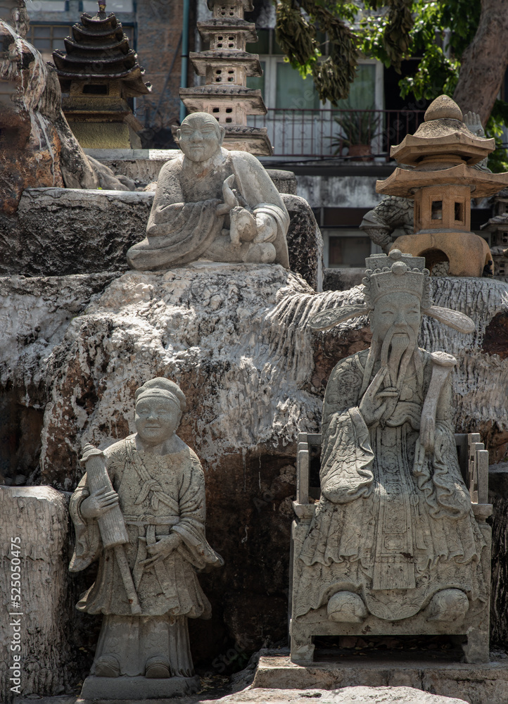 Various ancient chinese art stone elaborate sculptures in stone garden or rock garden of The Suthat hepwararam ratchaworamahawihan temple. Thailand, Selective focus.
