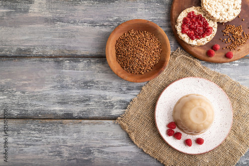 Buckwheat milk jelly on gray wooden  top view  copy space.