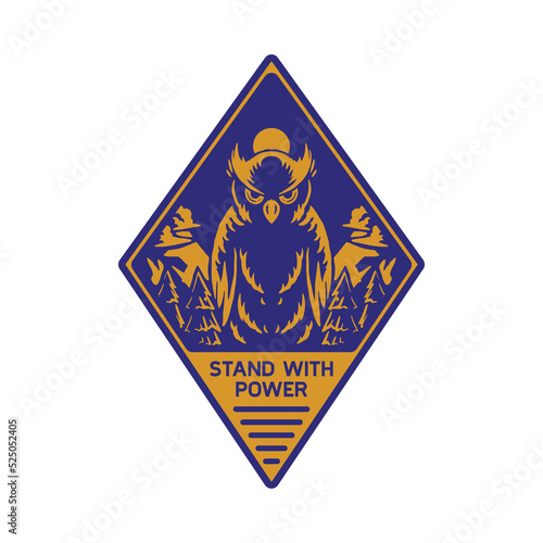 Diamond shaped emblem of standing great horned owl