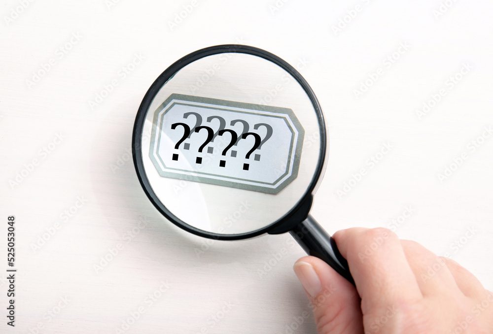 Concept of person seeing double. Person hand holding magnifying glass and looking text and seeing it double and blurred. Concept of person seeing double. Person hand holding magnifying glass and looking text and seeing it double and blurred.