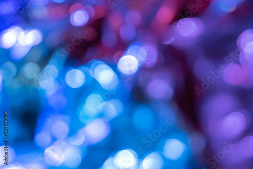 Blurred bokeh background for Christmas and New Year holiday. Abstract colorful wallpaper with defocused lights. Copy space