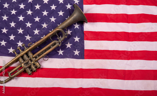Bild auf Leinwand Honoring US Army Veterans with trumpet on United States Flag