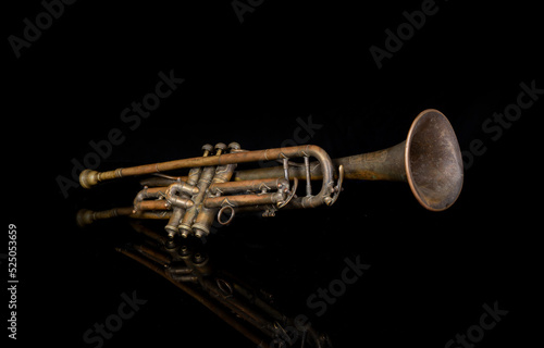 Photography Playing jazz music on vintage trumpet with black refection background