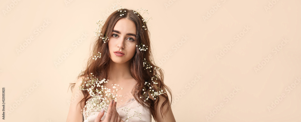 Φωτογραφία Beautiful young woman with flowers in her hair on beige background with space fo