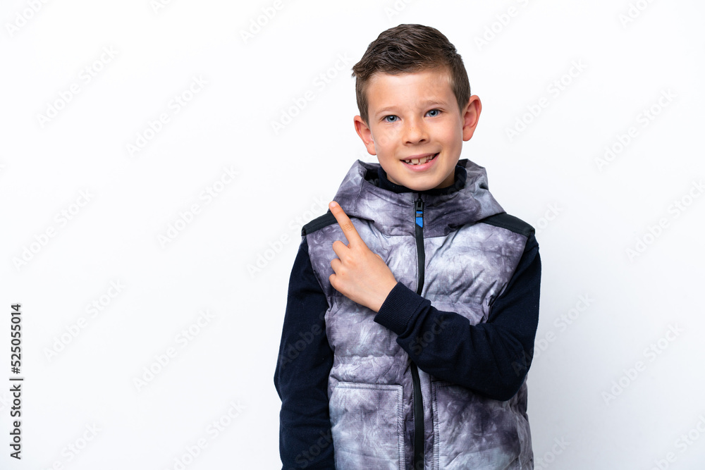 Little boy isolated on white background pointing to the side to present a product Little boy isolated on white background pointing to the side to present a product