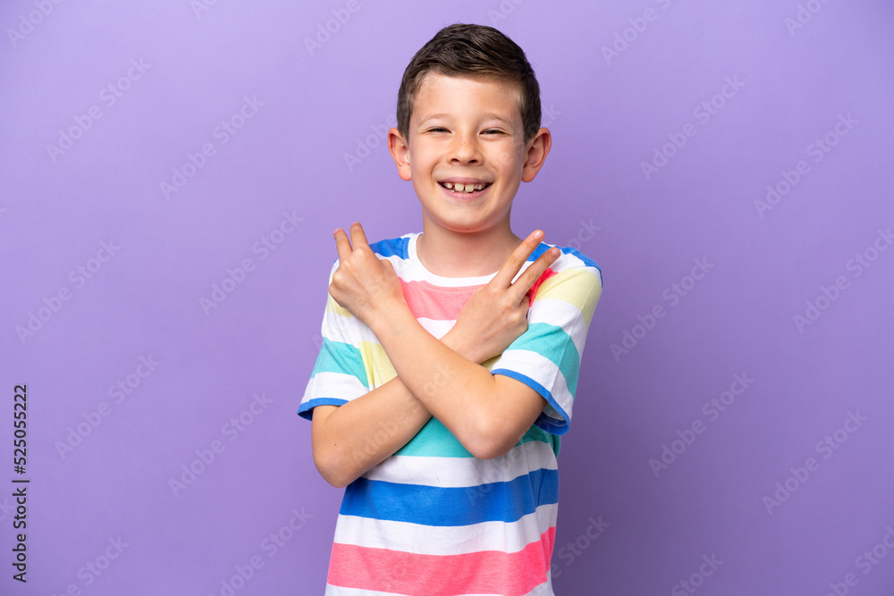 Little boy isolated on purple background smiling and showing victory sign Little boy isolated on purple background smiling and showing victory sign