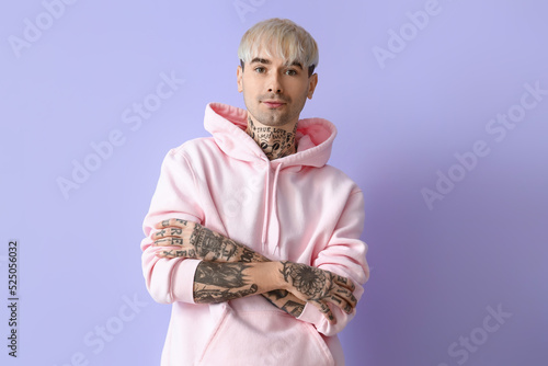 Young tattooed man in pink ...