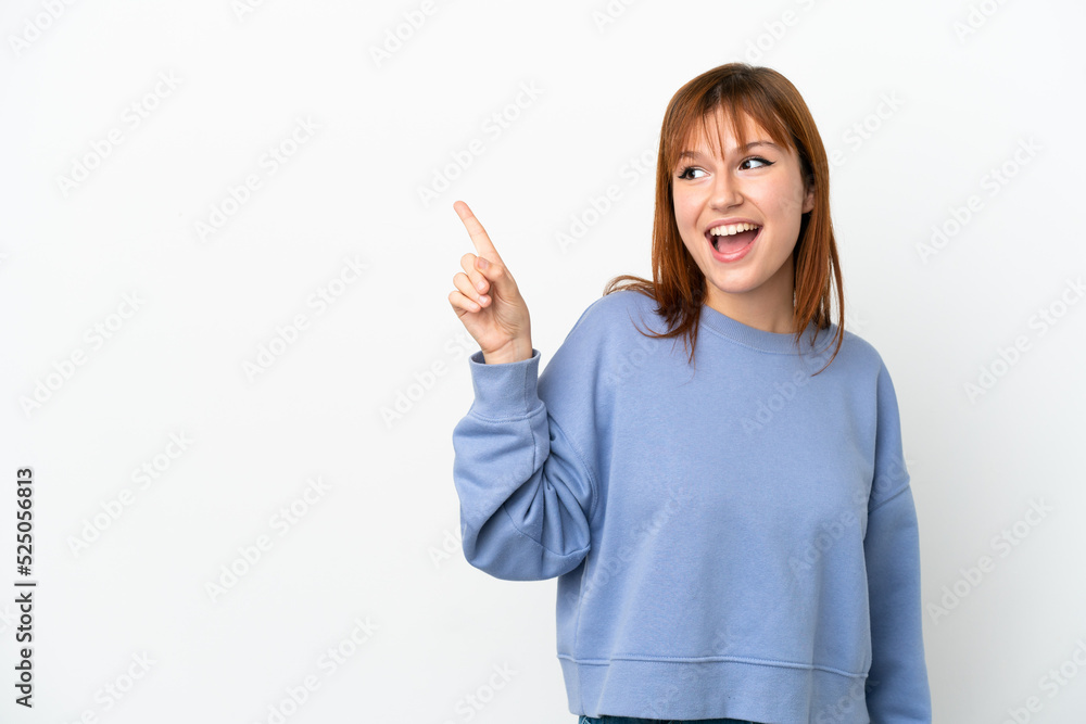 Redhead girl isolated on white background intending to realizes the solution while lifting a finger up Redhead girl isolated on white background intending to realizes the solution while lifting a finger up