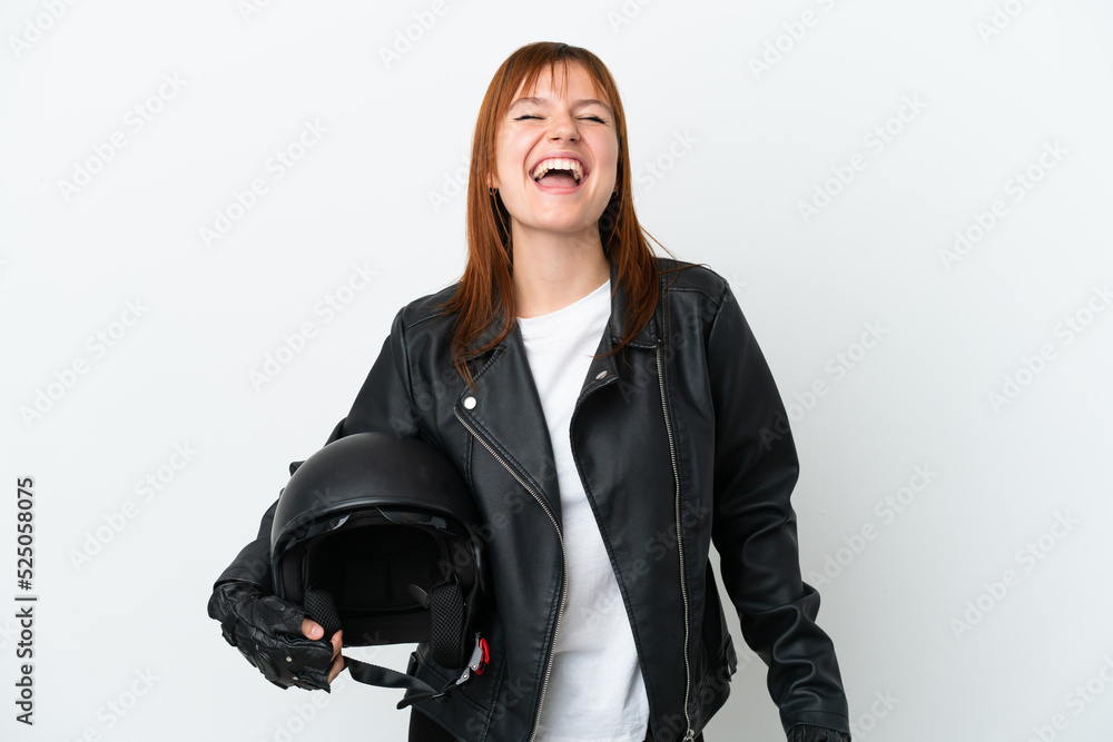 Redhead girl with a motorcycle helmet isolated on white background laughing Redhead girl with a motorcycle helmet isolated on white background laughing