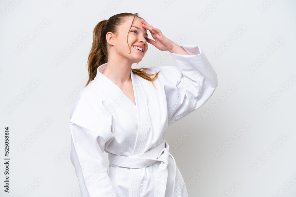 Young caucasian girl doing karate isolated on white background smiling a lot Young caucasian girl doing karate isolated on white background smiling a lot
