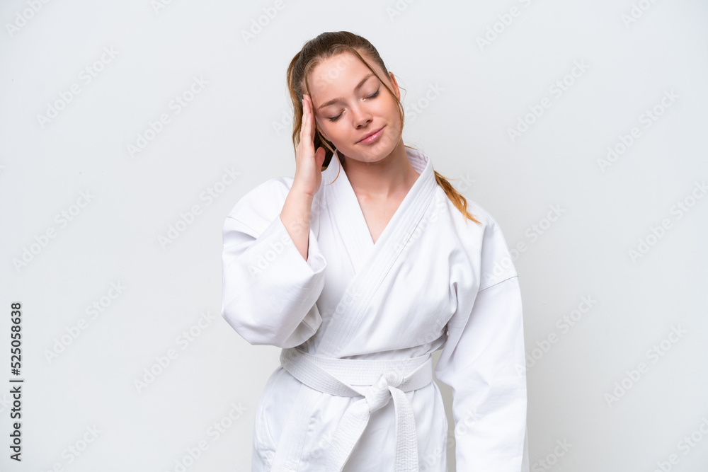 Young caucasian girl doing karate isolated on white background with headache Young caucasian girl doing karate isolated on white background with headache