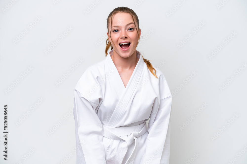 Young caucasian girl doing karate isolated on white background with surprise facial expression Young caucasian girl doing karate isolated on white background with surprise facial expression