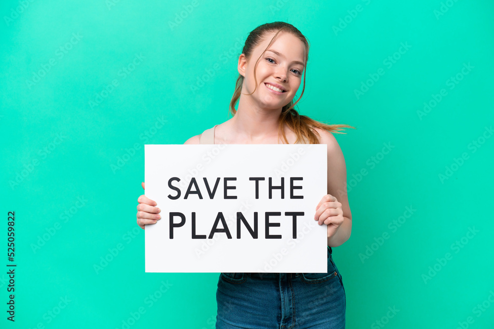 Young caucasian woman isolated on green background holding a placard with text Save the Planet with happy expression Young caucasian woman isolated on green background holding a placard with text Save the Planet with happy expression