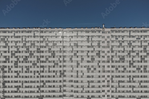 Facade of a nondescript residential monotonous multi-storey building.