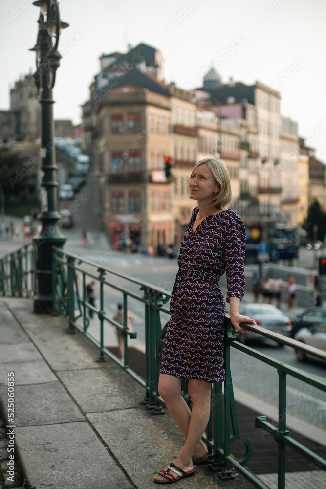 A middle-aged woman walks on a street in Porto, Portugal. A middle-aged woman walks on a street in Porto, Portugal.