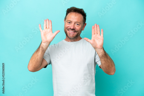 Middle age caucasian man isolated on blue background counting ten with fingers