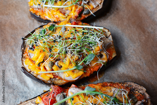 Homemade veggie food. Eggplants boats stuffed with mushrooms and vegan cheddar.