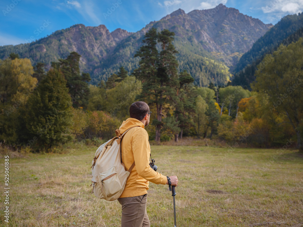 trip to Caucasus mountains, Arkhyz, Teberdinsky reserve. concept of discovery and exploration of wild places in early autumn. Man hiking in mountains with backpack and photo camera