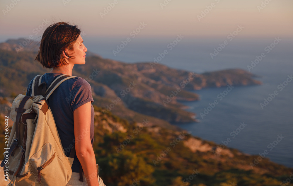 Travel to Turkey, viewpoint over Dalyan Iztuzu Beach. . Smiling woman taking break on hiking trip looking at view at sunset. Explore natural wonders of Turkey Travel to Turkey, viewpoint over Dalyan Iztuzu Beach. . Smiling woman taking break on hiking trip looking at view at sunset. Explore natural wonders of Turkey