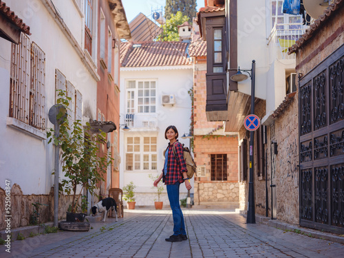travel to Turkey, old town Antalya Kaleci Famous tourist destination . Happy asian female tourist traveller with backpack walks in old city. © YURII Seleznov
