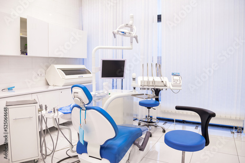 Interior of dental equipment in dentist office in new modern stomatological clinic room. Background of dental chair and accessories used by dentists in blue color. Copy space, text place
