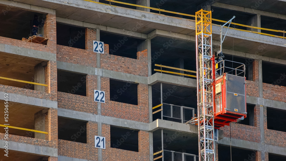 Construction elevator with workers in lifting up. Fast speed motion. Construction elevator with workers in lifting up. Fast speed motion.