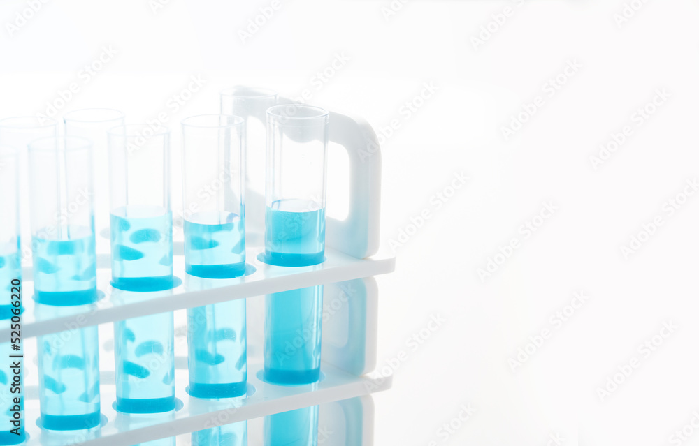 concept of science biology test tube with blue liquid on white background concept of science biology test tube with blue liquid on white background