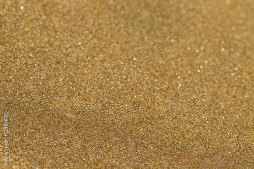 Abstract beige sand background with gold particles for design