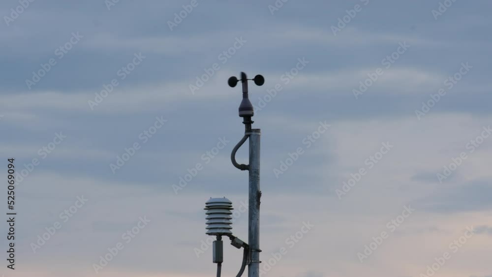 Weather station for measuring wind velocity. Anemometer on blue sky with clouds. Monitor weather. Precision farming equipment