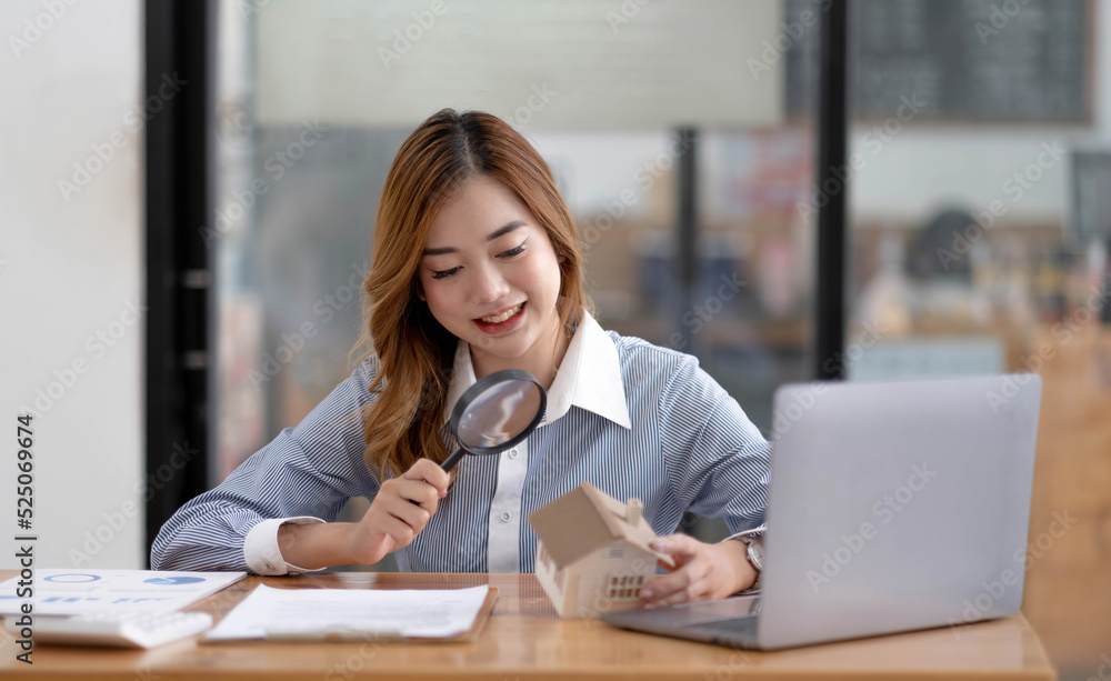 Close up of businesswomen holding magnifying glass finding a wooden shape of a house, realtor, agent, insurance, developer, planning and investment real estate business concept, Close up of businesswomen holding magnifying glass finding a wooden shape of a house, realtor, agent, insurance, developer, planning and investment real estate business concept,