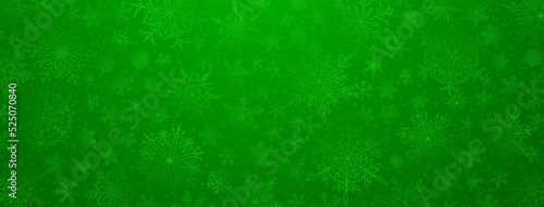 Background of complex big and small Christmas snowflakes in green colors. Winter illustration with falling snow