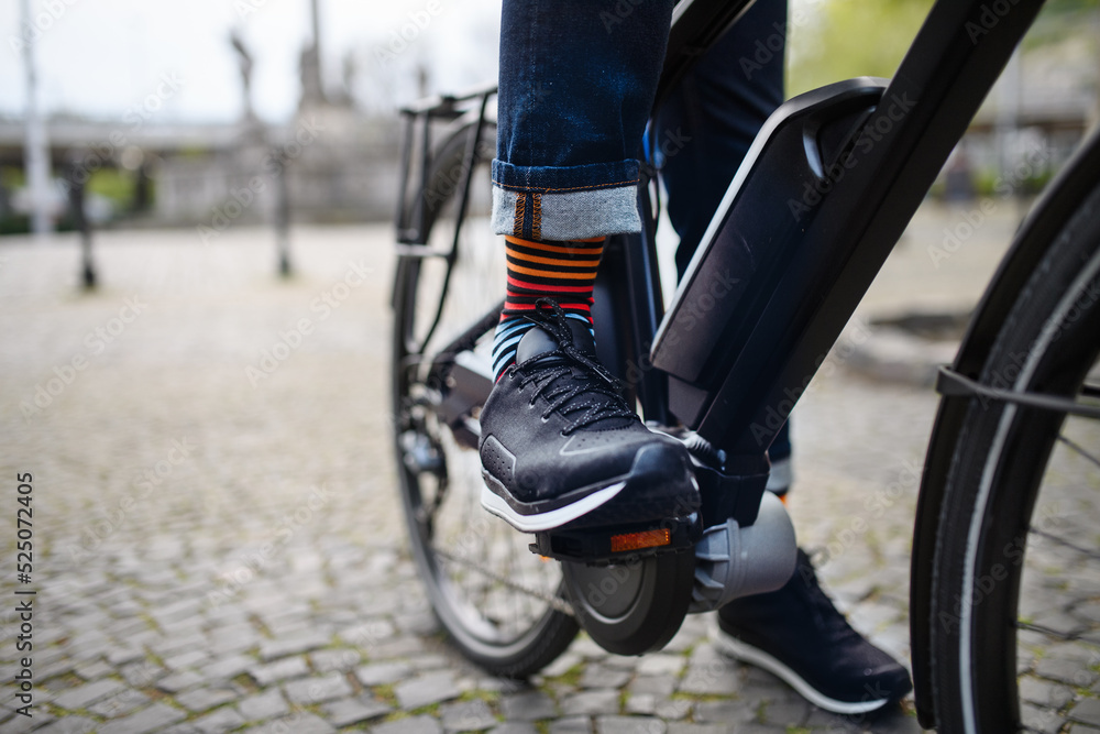 Businessman commuter on the way to work, close up of his legs riding bicycle. Businessman commuter on the way to work, close up of his legs riding bicycle.