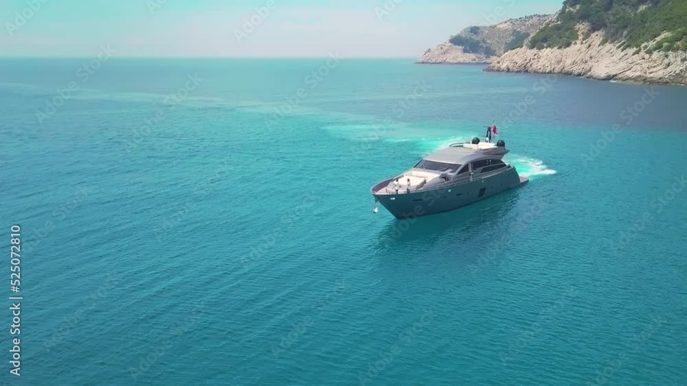 Aerial drone tracking video of luxury yacht cruising in deep blue open ocean sea Aerial drone tracking video of luxury yacht cruising in deep blue open ocean sea
