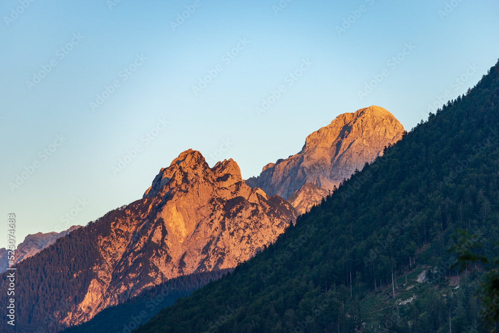 Mountain Range and the peak of the Mount Mangart (2677 m.) at sunset, seen from the small village of Camporosso, Julian Alps, Tarvisio, Udine, Friuli Venezia Giulia, Italy Slovenia border, Europe.