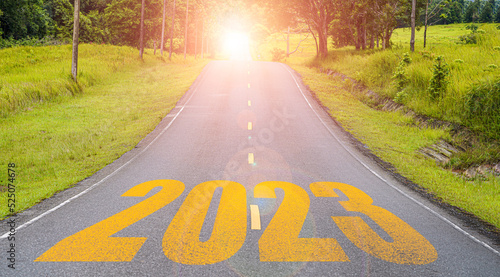 Yellow 2023 on long asphalt road for up coming of merry Christmas and happy new year concept.