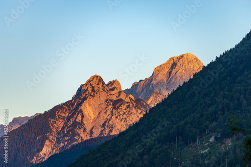 Mountain Range and the peak of the Mount Mangart (2677 m.) at sunset, seen from the small village of Camporosso, Julian Alps, Tarvisio, Udine, Friuli Venezia Giulia, Italy Slovenia border, Europe. © Alberto Masnovo