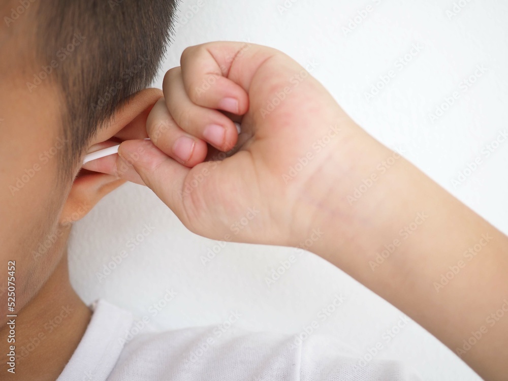 Little boy cleaning ear with cotton bud. closeup photo, blurred. Little boy cleaning ear with cotton bud. closeup photo, blurred.