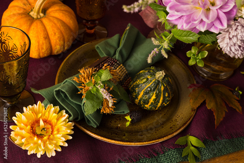 Festive table setting for Thanksgiving day. Autumnal decorations,plates, mult...