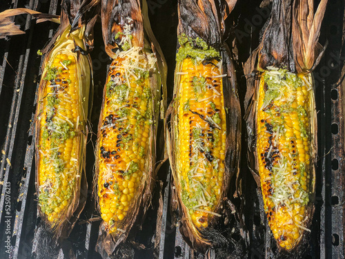 GRILLED CORN COVERED IN SPICY AIOLI AND PARMESAN