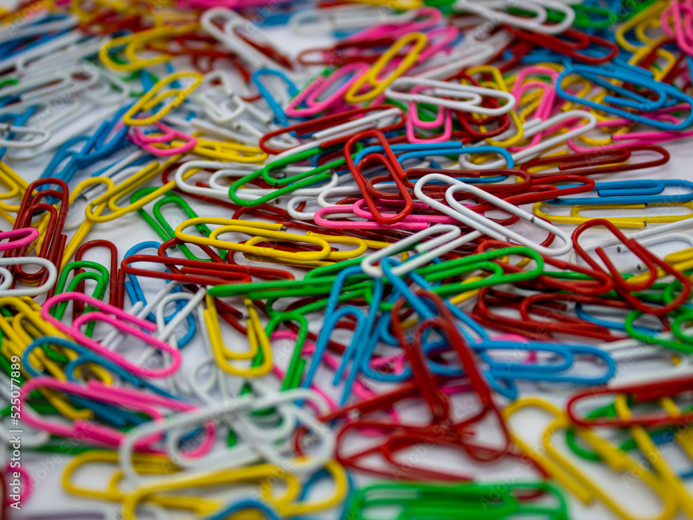 close up selective focus of colorful paperclip as a background and texture with white background in the office